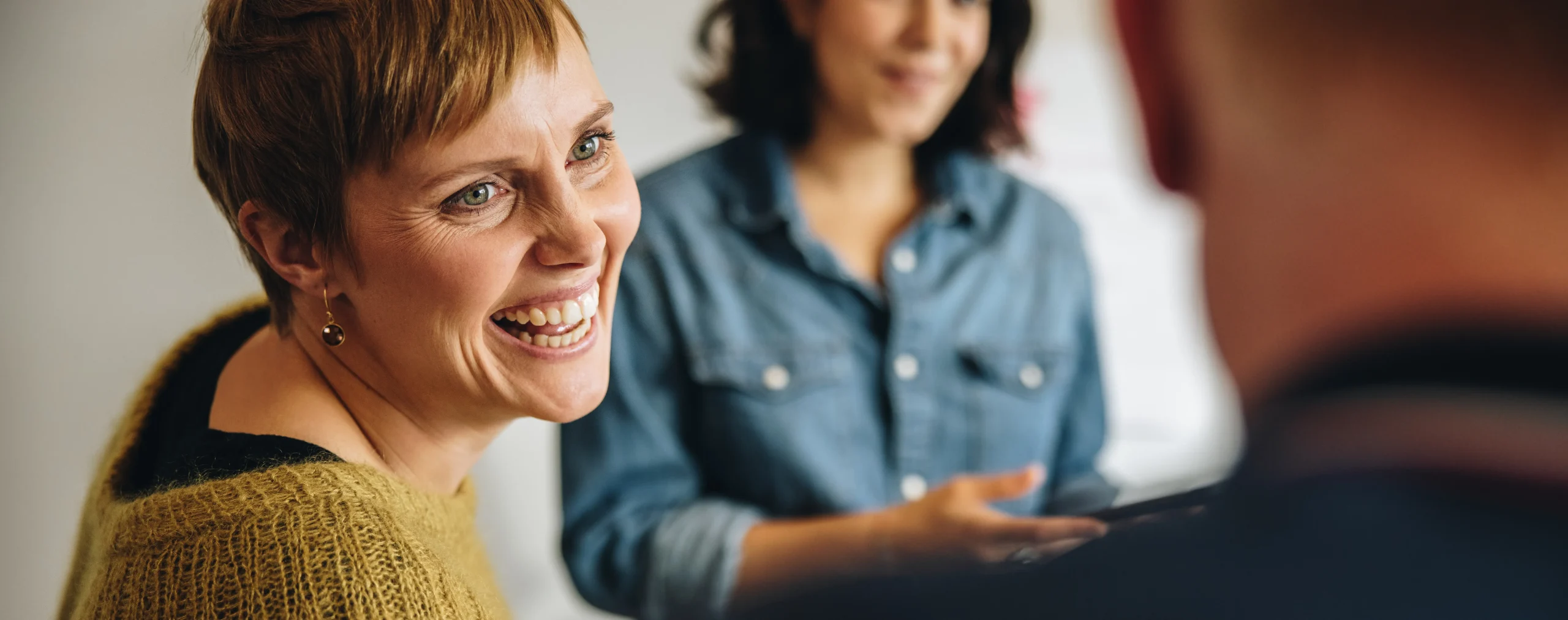 Happy gay couple on the sofa with coffee