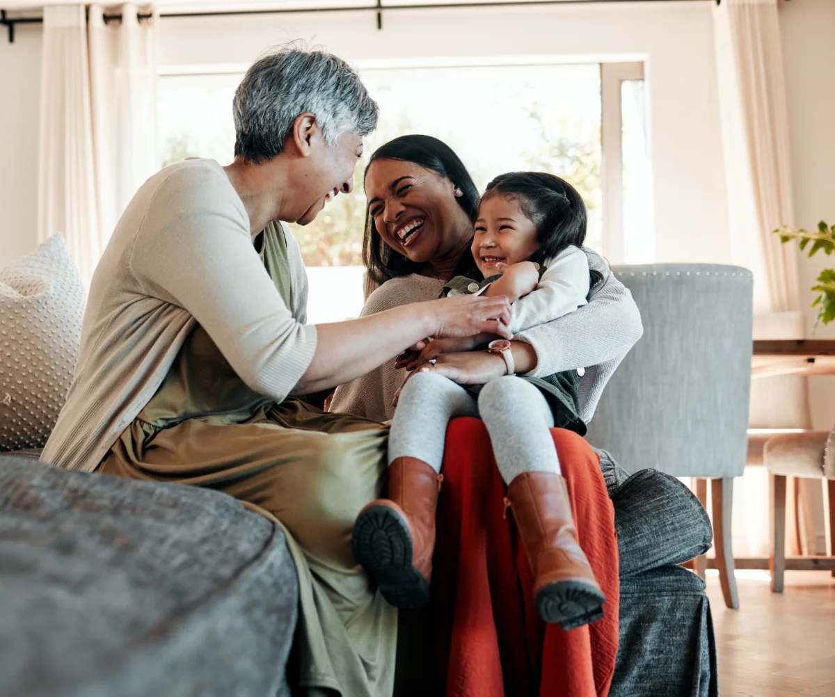 Happy playful family on a sofa for a visit