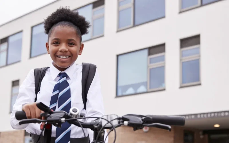 Girl with bike at school