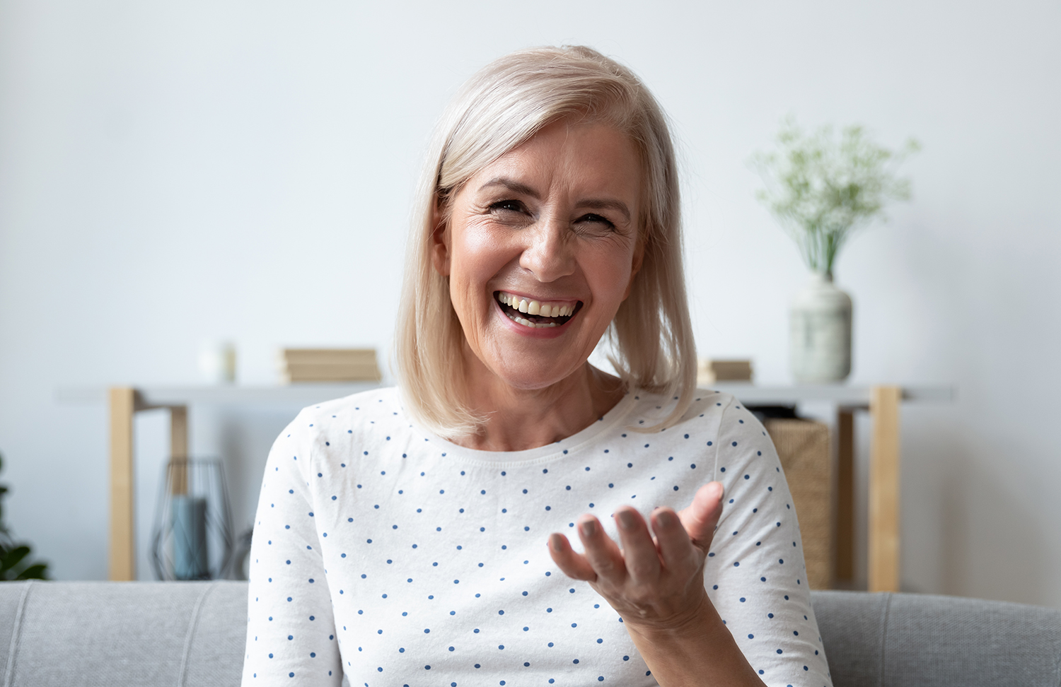 Happy mature blonde lady holding video call with friends. Happy mature blonde lady holding video call with friends.